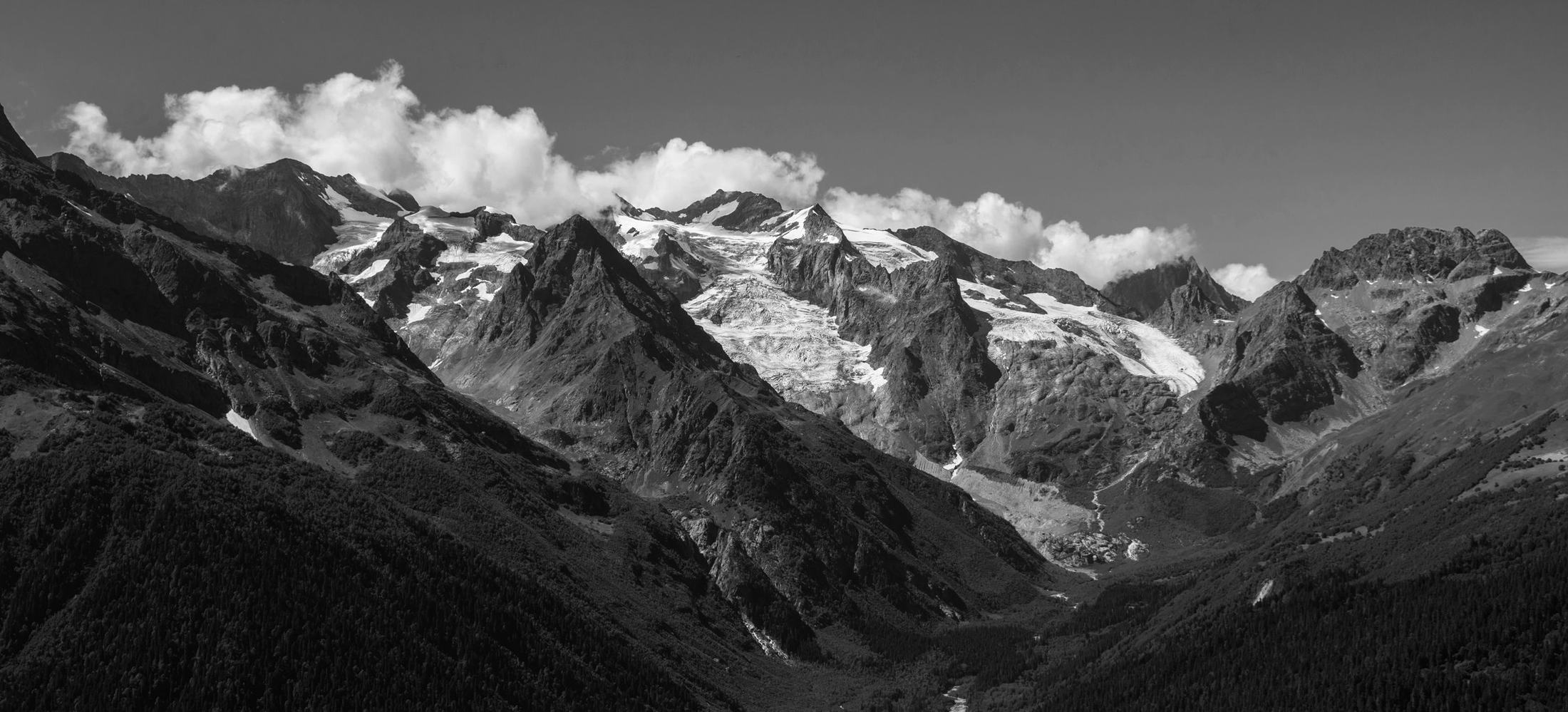 A grayscale mountain valley